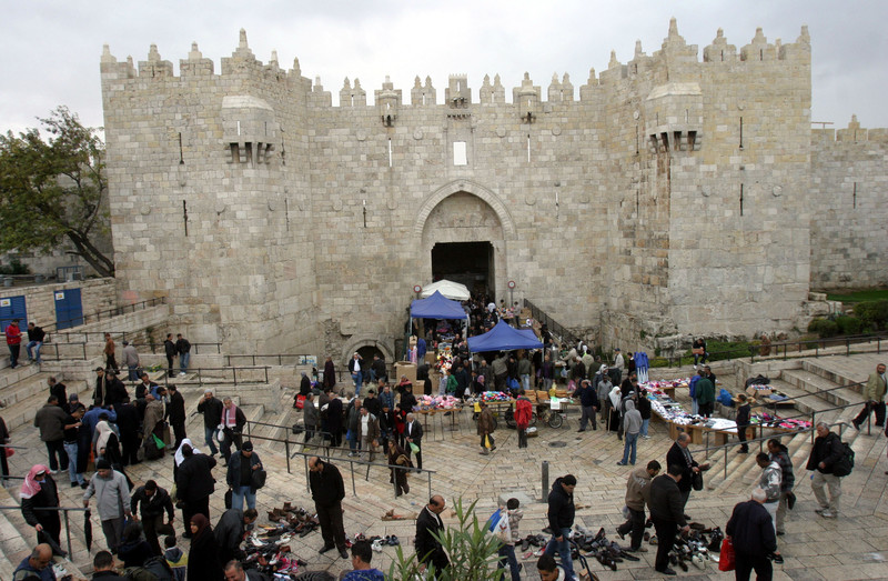 Palestinians walk outside Damascus Gate leading into the old city of Jerusalem from their way from Friday prayers in the Al-Aqsa Mosque compound, Islam's third holiest site, on November 18, 2011. Photo by Mahfouz Abu Turk