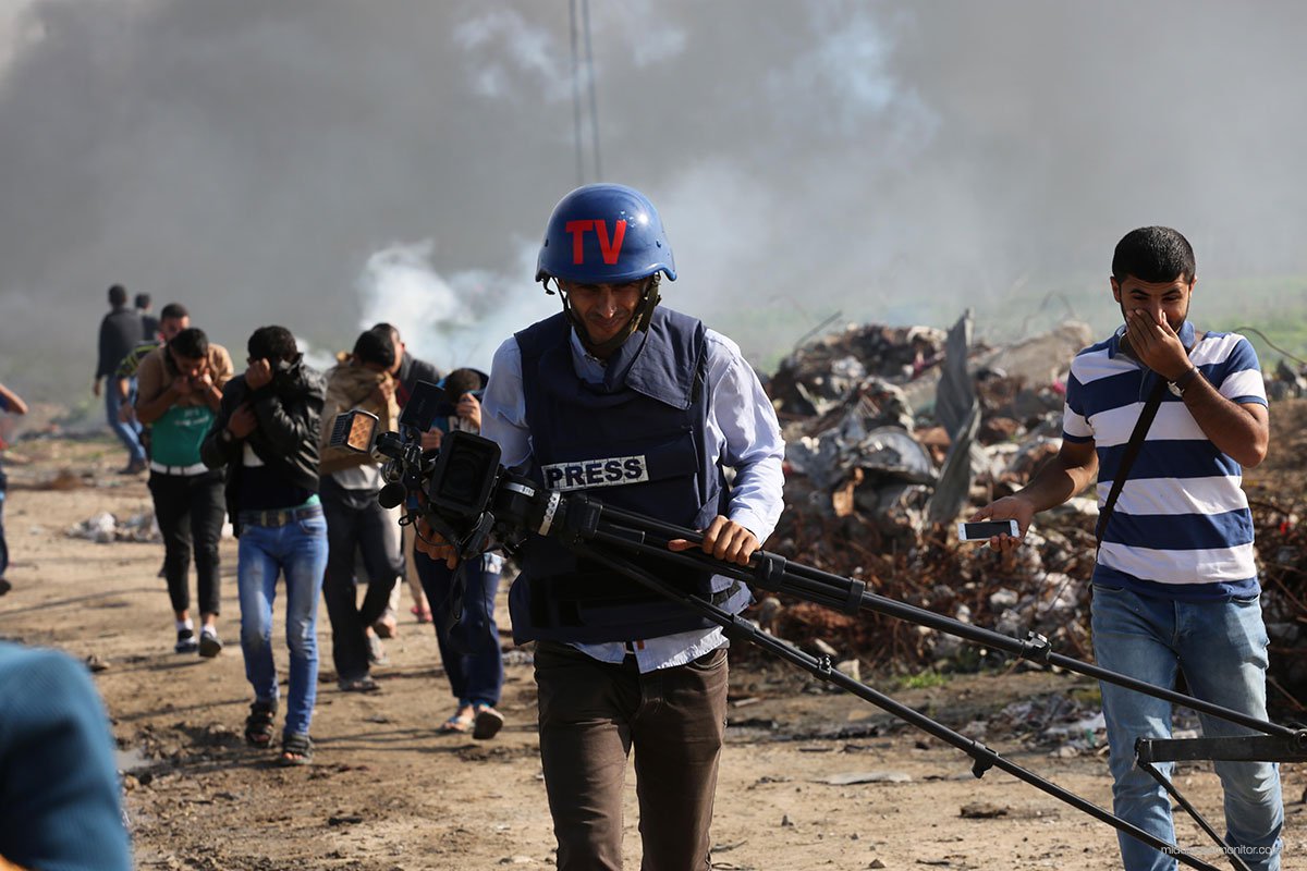 Press-journalist-flees-from-tear-gas-shot-by-Israeli-at-border-in-gaza
